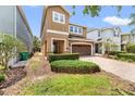 Inviting two-story home with a brick-paved driveway, well-maintained landscaping, and a two-car garage at 480 Lasso Dr, Kissimmee, FL 34747