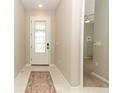 Bright foyer with tile flooring, leading into the home's inviting living spaces at 5089 Meadow Song Dr, Okahumpka, FL 34762