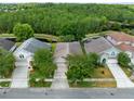 A higher aerial view of the home, showing proximity to ponds and green wooded areas at 516 Brett Ct, Orlando, FL 32828