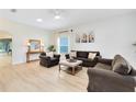 Bright living room features neutral decor, updated floors, ceiling fan, and comfortable seating at 516 Brett Ct, Orlando, FL 32828