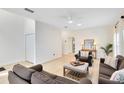 The living room has neutral decor, updated floors, lots of natural light, and comfortable seating at 516 Brett Ct, Orlando, FL 32828