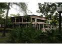 Modern two-story building featuring large windows, surrounded by lush green landscaping and mature trees at 518 W Plantation Blvd, Lake Mary, FL 32746