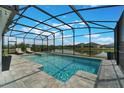 Beautiful screened-in pool and spa with lake view, perfect for relaxation at 5226 Northern Flicker Dr, St Cloud, FL 34771