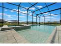 Beautiful screened-in pool and spa overlooking a serene lake at 5226 Northern Flicker Dr, St Cloud, FL 34771