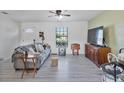 Comfortable living room with stylish decor, large window, and modern gray vinyl flooring at 601 Blackstone Ave, Deltona, FL 32725