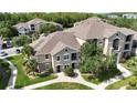Beautiful tan condo building with mature landscaping, sidewalks, and palm trees at 6512 Swissco Dr # 1428, Orlando, FL 32822