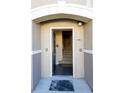 View of front door showcasing the home's entry to carpeted stairs and tile flooring at 6512 Swissco Dr # 1428, Orlando, FL 32822