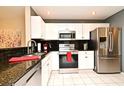Contemporary kitchen with stainless steel appliances, white cabinets, and black granite countertops at 677 Post Oak Cir # 115, Altamonte Springs, FL 32701