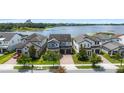 Aerial shot of a home in a lakeside community with manicured lawns at 7500 Alpine Butterfly Ln, Orlando, FL 32819