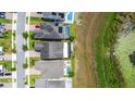 Bird's eye view of a neighborhood showcasing backyard pools and proximity to a lake at 7500 Alpine Butterfly Ln, Orlando, FL 32819