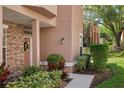 Close exterior shot of the front entrance featuring a decorative stone wall and beautifully landscaped yard at 7628 Bay Port Rd # 43, Orlando, FL 32819