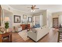 Cozy living room features hardwood flooring, neutral paint, lots of natural light and comfortable seating at 7628 Bay Port Rd # 43, Orlando, FL 32819