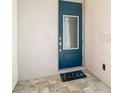 Stylish blue front door features a glass insert and a welcoming 'hello' doormat at 812 Driving Range Ct, Reunion, FL 34747