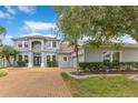 Beautiful two-story home showcases manicured landscaping, a spacious driveway, and a charming facade at 8676 Currituck Sound Ln, Orlando, FL 32829