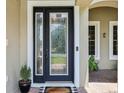 Elegant front door with decorative glass, framed by white trim and a welcoming doormat at 9843 Nokay Dr, Orlando, FL 32836