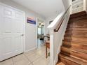 Inviting entryway with wooden stairs, tiled floors, and a view into a bright living space at 1027 Cedar Bay Ln, Winter Springs, FL 32708