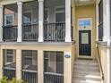 Charming townhome with a covered porch, black railings, and a welcoming entrance at 1027 Cedar Bay Ln, Winter Springs, FL 32708