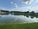Scenic view of a tranquil pond with a fountain and lush green surroundings at 1027 Cedar Bay Ln, Winter Springs, FL 32708