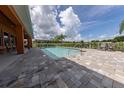 Community pool with lounge seating and a paved deck for residents' enjoyment at 1027 Cedar Bay Ln, Winter Springs, FL 32708