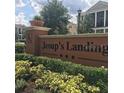 Entrance sign for Jesup's Landing surrounded by lush green landscaping at 1027 Cedar Bay Ln, Winter Springs, FL 32708