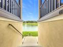 Scenic view of a tranquil lake with a fountain, framed by stucco walls and black railings at 1027 Cedar Bay Ln, Winter Springs, FL 32708