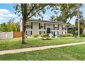 Two-story home features a well-manicured lawn, symmetrical design, and classic black shutters at 103 Cherry Hill Cir, Longwood, FL 32779