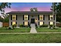 Charming two-story home with a manicured lawn and decorative shutters, exudes classic curb appeal at 103 Cherry Hill Cir, Longwood, FL 32779