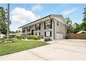 Two-story home with long driveway, lush lawn, and symmetrical window and shutter design at 103 Cherry Hill Cir, Longwood, FL 32779