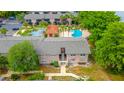 Aerial view of the condo complex featuring lush landscaping, community pools and ample parking at 1177 Paseo Del Mar # D, Casselberry, FL 32707