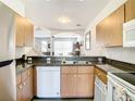 Functional kitchen with stainless steel appliances, and granite countertops at 1201 S Beach Cir, Kissimmee, FL 34746