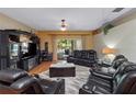 View of the living room with media center, seating area, and natural light at 1319 Castleport Rd, Winter Garden, FL 34787
