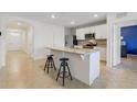 Modern kitchen with stainless steel appliances, granite countertops, and an island with seating at 1511 Barberry Dr, Kissimmee, FL 34744