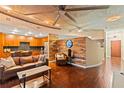 Open-concept living room with hardwood floors, wood paneling, and a modern kitchen at 155 S Court Ave # 1608, Orlando, FL 32801