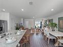 Bright, open-concept living space featuring a modern kitchen, dining area, and cozy living room at 1562 Dalehurst Ln, Kissimmee, FL 34744