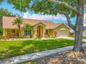 Charming single-story home with a well-manicured lawn and beautiful landscaping at 1846 Branchwater Trl, Orlando, FL 32825