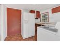 Bright eat-in kitchen with white appliances and wooden cabinets at 2045 South St, Oviedo, FL 32765