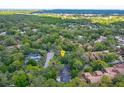 Aerial view showing property's location surrounded by lush greenery and a dense tree canopy in the neighborhood at 209 Sweet Gum Way, Longwood, FL 32779