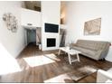 Open-concept living room featuring modern decor, sleek flooring, and a stylish fireplace with flat screen television at 209 Sweet Gum Way, Longwood, FL 32779
