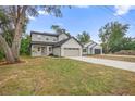 Two story home with a gray exterior, a front-facing two-car garage, and a long concrete driveway at 2137 Brighton Ln, Orlando, FL 32817