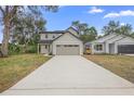 Two story home with a gray exterior, a front-facing two-car garage, and a long concrete driveway at 2137 Brighton Ln, Orlando, FL 32817