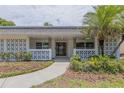 Inviting home entrance with decorative concrete screen, manicured landscaping, and a stylish front door at 2171 Chippewa Trl, Maitland, FL 32751