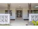 A welcoming front porch featuring decorative concrete screen walls and an elegant glass front door at 2171 Chippewa Trl, Maitland, FL 32751
