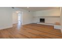 Spacious living room featuring a traditional brick fireplace with a wooden mantel at 2171 Chippewa Trl, Maitland, FL 32751