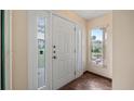 Bright foyer with a white door and sidelights, tile flooring, and view to outdoors at 2316 Irlo Dr, Kissimmee, FL 34741