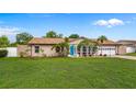 Charming single-story home with a lush lawn and mature landscaping at 2316 Irlo Dr, Kissimmee, FL 34741