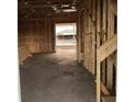 Unfinished interior showcases open layout with exposed wooden framing and concrete flooring at 2383 Zuni Road, St Cloud, FL 34771