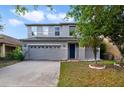 Two-story home featuring a neutral paint scheme, a two car garage, and simple landscaping at 2724 Amanda Kay Way, Kissimmee, FL 34744