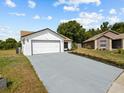 Attractive single-story home with a two-car garage, fresh landscaping, and a spacious driveway at 274 W 20Th St, Apopka, FL 32703