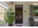 Inviting front porch with a solid wood door, house number, and a welcoming plant at 308 Michael Blake Blvd, Winter Springs, FL 32708