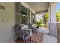 Welcoming front porch featuring comfortable seating, a small glass table, and neutral colors at 308 Michael Blake Blvd, Winter Springs, FL 32708